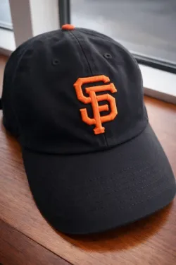 Black San Francisco Giants baseball cap with orange SF logo.